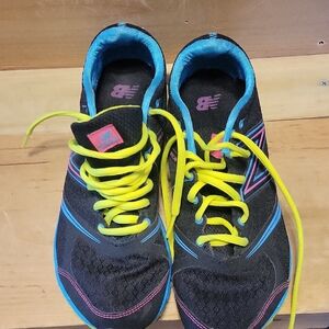 New Balance Black Athletic Sneakers with Blue Trim and Neon Yellow Laces